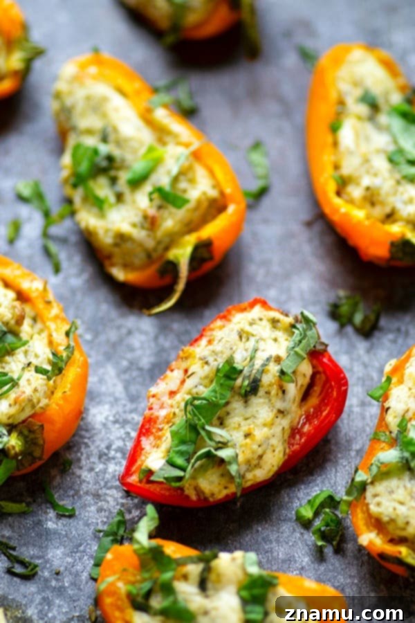 Mini Pesto Sweet Pepper Poppers 5 Pesto Stuffed Sweet Pepper Poppers - Stuffed with a super flavorful creamy pesto filling, these pesto stuffed sweet pepper poppers are SUPER addicting and the perfect little party app!