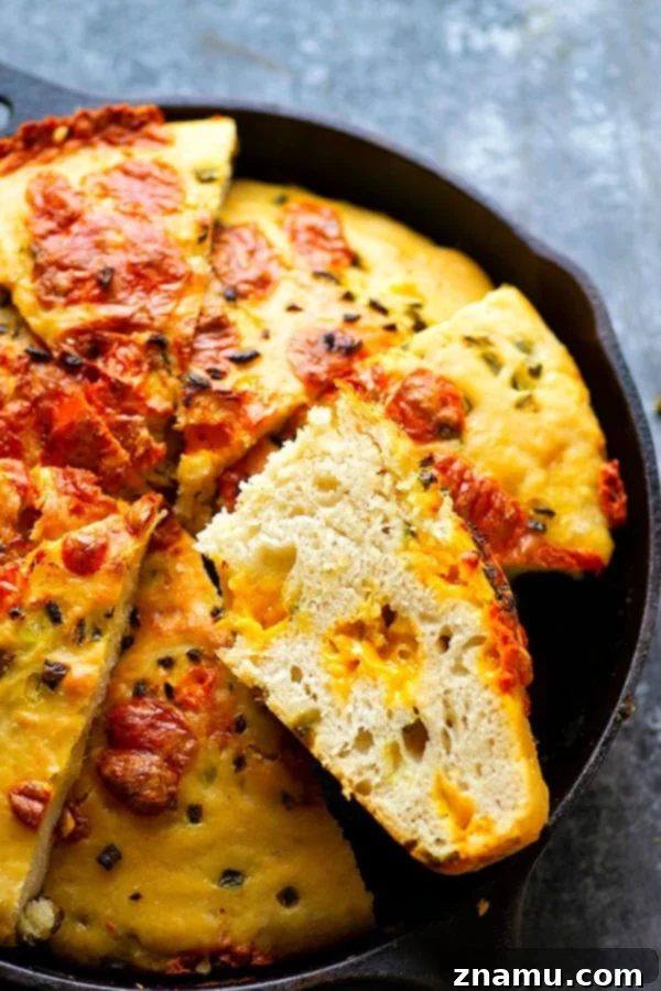 Pillowy soft Jalapeno Cheddar Focaccia with melted cheese pockets and fresh jalapeno slices
