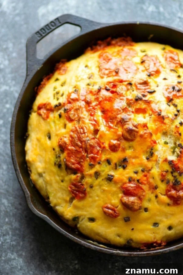 Close-up of a freshly baked Jalapeno Cheddar Focaccia with a golden crust and visible cheese and jalapenos