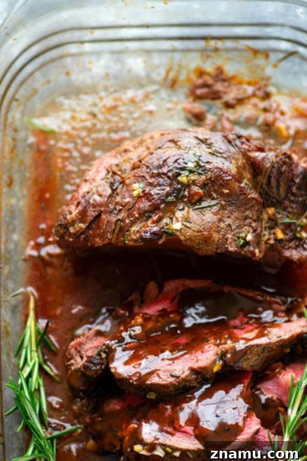 Rosemary Garlic Butter Beef Tenderloin - Roasted to perfection in a flavorful rosemary garlic butter and covered in hearty red wine sauce, this rosemary garlic butter beef tenderloin is an easy, yet impressive entree for any dinner crowd.