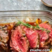 Rosemary Garlic Butter Beef Tenderloin - Roasted to perfection in a flavorful rosemary garlic butter and covered in hearty red wine sauce, this rosemary garlic butter beef tenderloin is an easy, yet impressive entree for any dinner crowd.