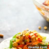 Spicy Peanut Thai Mango Chicken Lettuce Wraps - A creamy peanut sauce and spicy Thai flavors collide in these colorful mango chicken lettuce wraps that are a perfect lighter lunch or dinner!