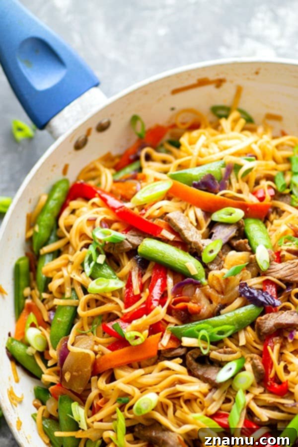 Garlic Sweet Pepper Steak Lo Mein - Juicy steak strips, a rainbow of fresh veggies, and tender lo mein noodles collide in this weeknight-friendly steak lo mein.