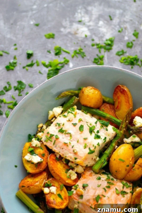 Sheet Pan Greek Salmon - Made entirely on one sheet pan and packed FULL of incredible Greek flavors, this Greek salmon and fingerling potatoes will quickly become a regular part of the dinner rotation!