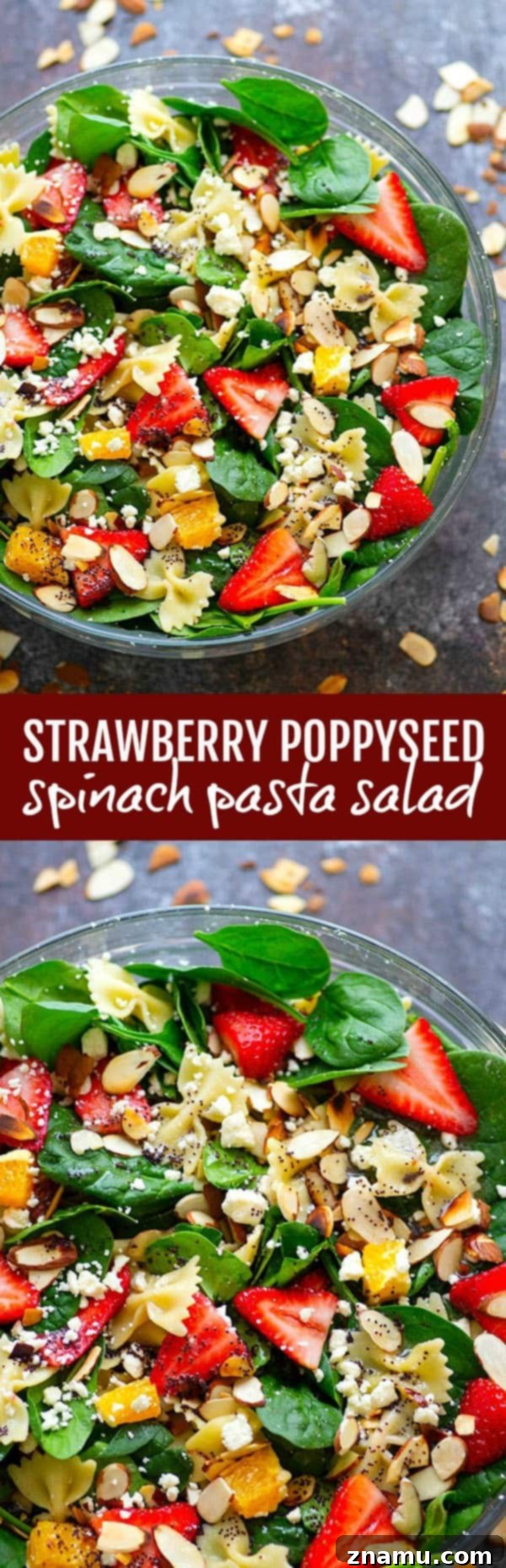 An overhead shot of a large bowl of Strawberry Poppyseed Spinach Pasta Salad, showcasing the abundant and colorful ingredients. The bowl is filled with bowtie pasta, fresh spinach, sliced strawberries, crumbled feta, and orange segments, generously coated in a poppyseed dressing, ready for serving.