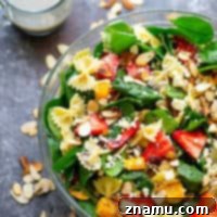 A vibrant and refreshing Strawberry Poppyseed Spinach Pasta Salad, perfect for a healthy and delicious meal or side dish.