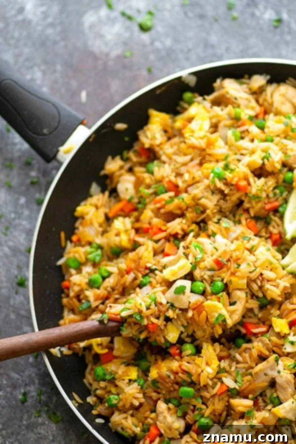 Herby Citrus Chicken Fried Rice 4 A generous serving of Cilantro Lime Chicken Fried Rice in a rustic bowl, garnished with more fresh cilantro.