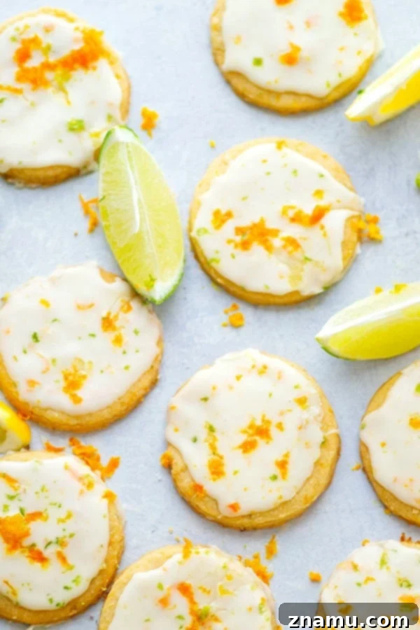 Zesty Brown Butter Shortbread 3 Close-up of golden browned butter shortbread cookies dusted with citrus zest and a white glaze.