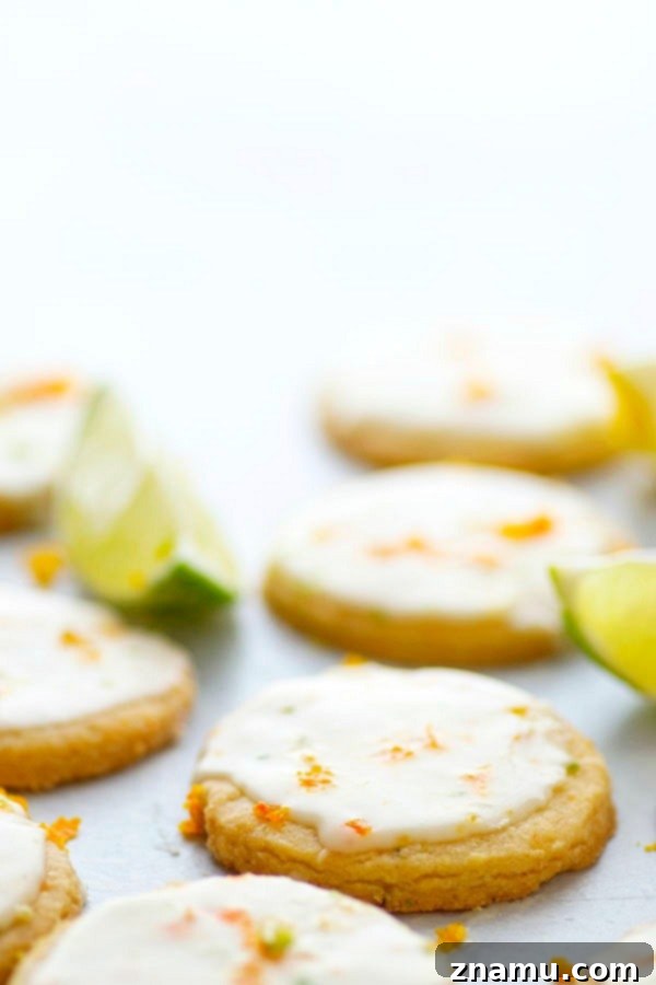 Zesty Brown Butter Shortbread 5 Hand dipping a shortbread cookie into a white citrus glaze.