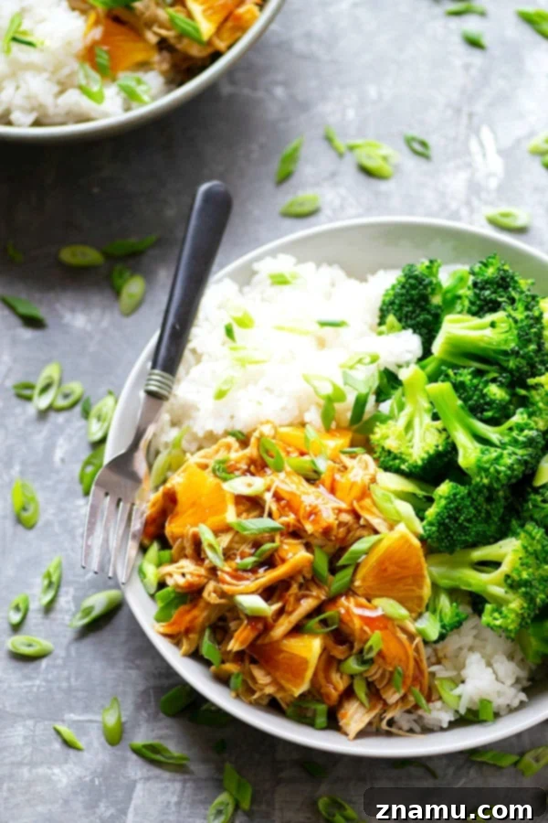 A vibrant close-up of the homemade orange sauce simmering in a skillet, showcasing its rich color and thick consistency, an essential part of the Instant Pot Orange Chicken recipe.