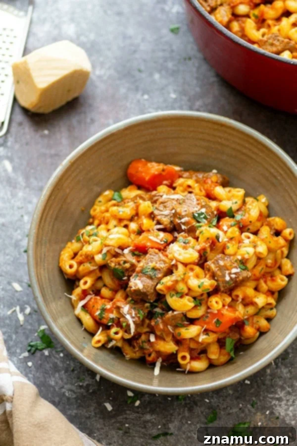 Soul-Satisfying One-Pot Beef Goulash 3 Close-up of tender, slow-braised beef chuck cubes nestled in a rich goulash sauce with carrots and onions, perfect for a hearty dinner.