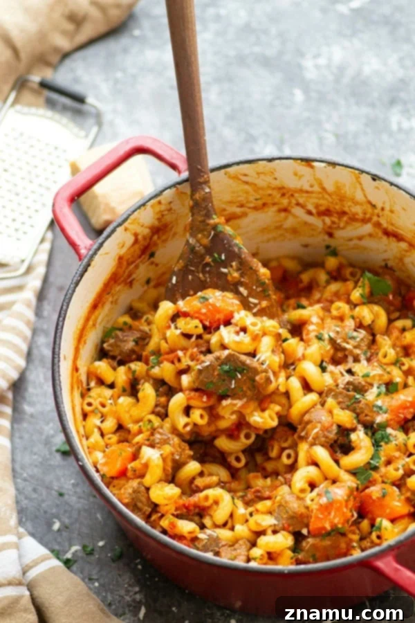 Soul-Satisfying One-Pot Beef Goulash 4 A vibrant selection of fresh goulash ingredients including cubed beef chuck, diced onions, carrots, bell peppers, garlic cloves, and a can of whole tomatoes.