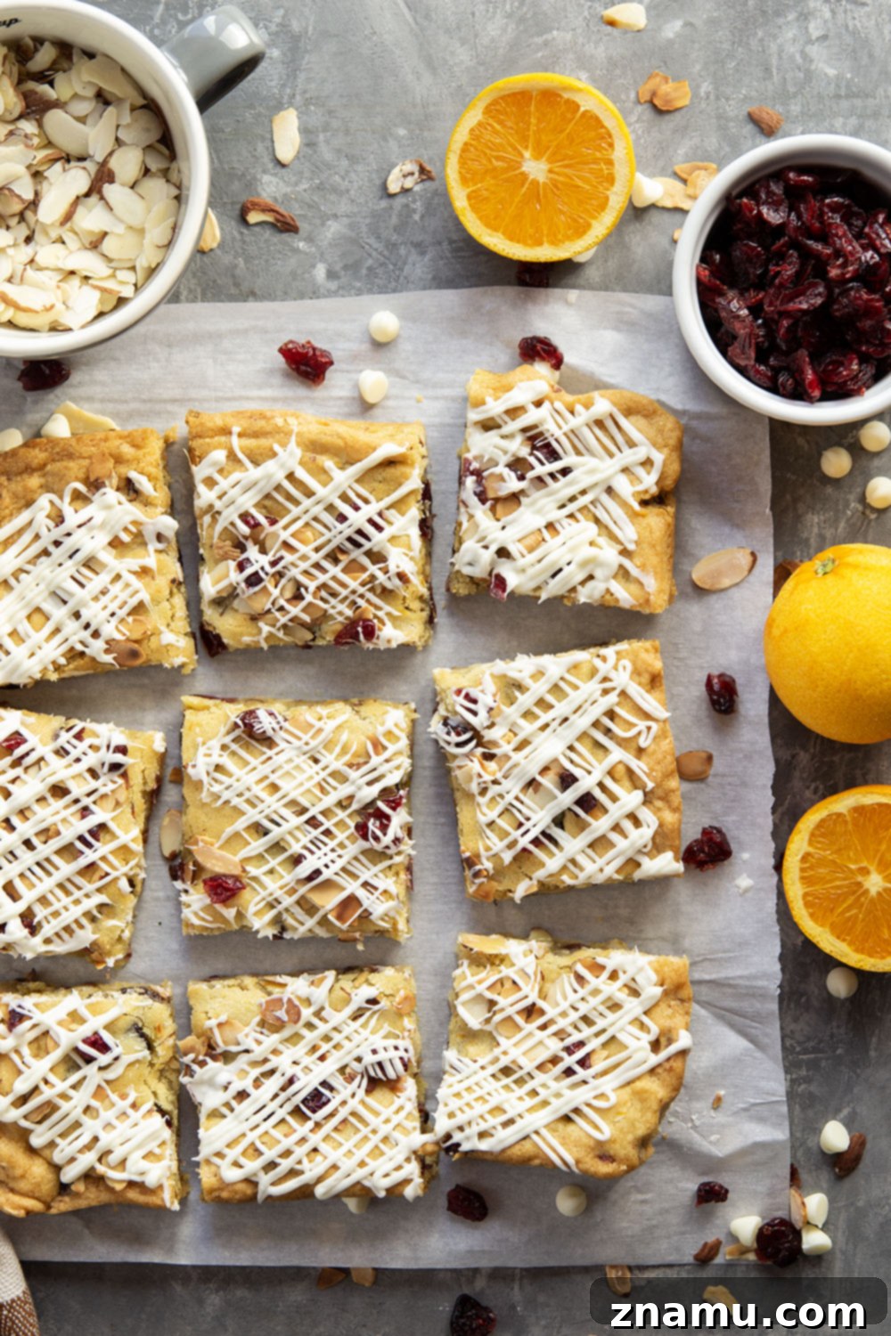 Buttery Cranberry Almond Bars 6 A plate of soft, chewy cranberry almond bars, garnished with extra cranberries and almonds, ready to be served.