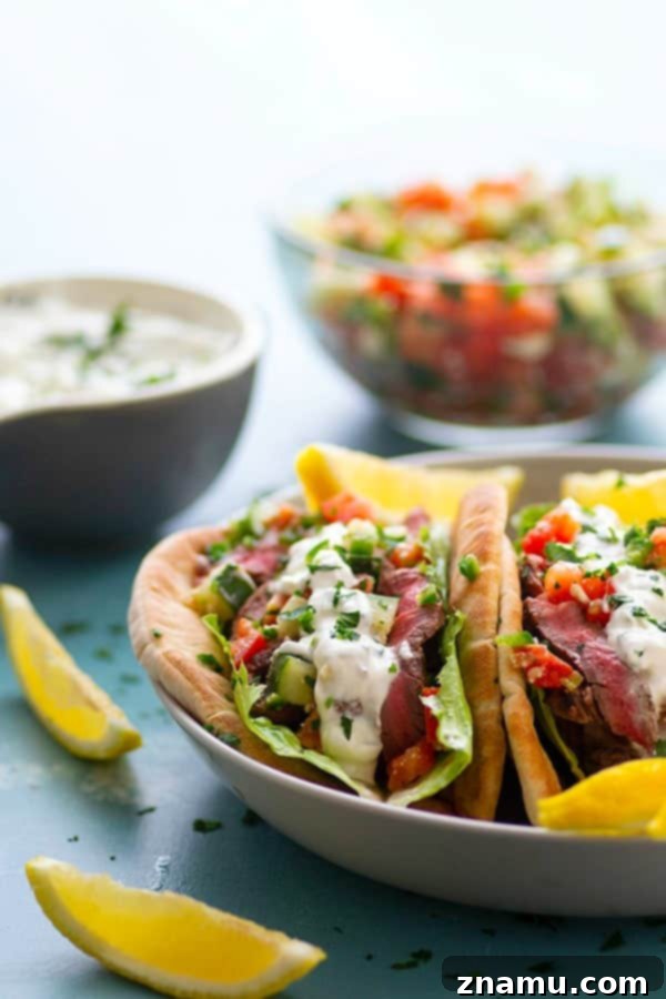 Savory Grilled Steak Gyros with Bright Feta-Cucumber Salsa and Cool Tzatziki 3 Close-up of a delicious grilled steak gyro with fresh ingredients