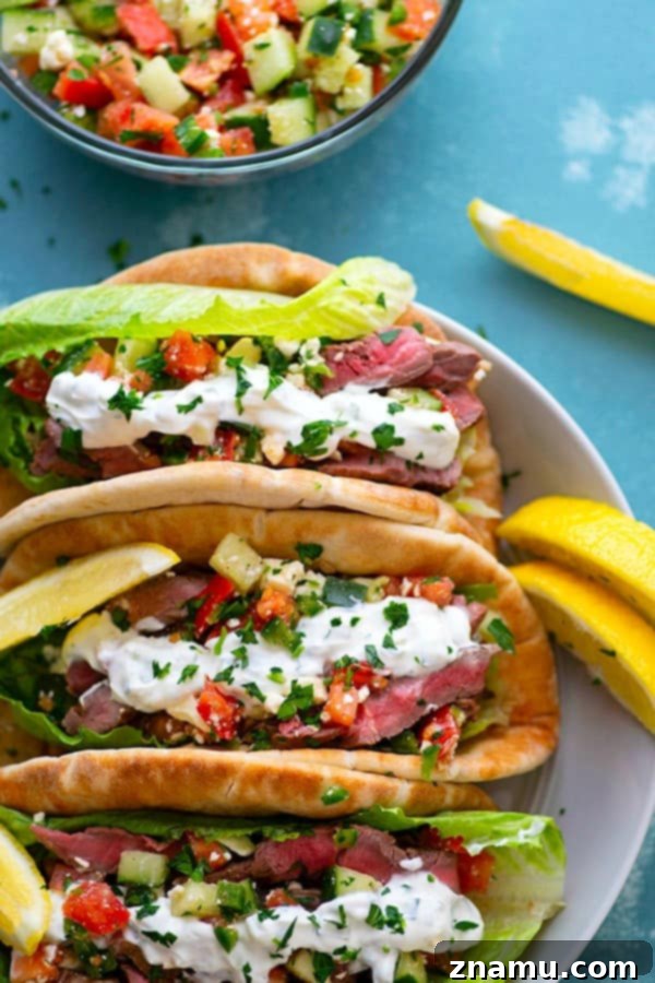 Savory Grilled Steak Gyros with Bright Feta-Cucumber Salsa and Cool Tzatziki 5 Assembling a grilled steak gyro with cucumber feta salsa and tzatziki sauce
