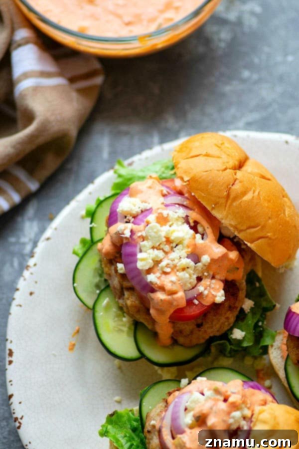 Mediterranean Chicken Burgers with Smoky Red Pepper Tzatziki 2 Grilled chicken burgers are piled high with fresh Greek toppings and a creamy red roasted red pepper tzatziki sauce for an incredibly flavorful Greek twist on burgers!