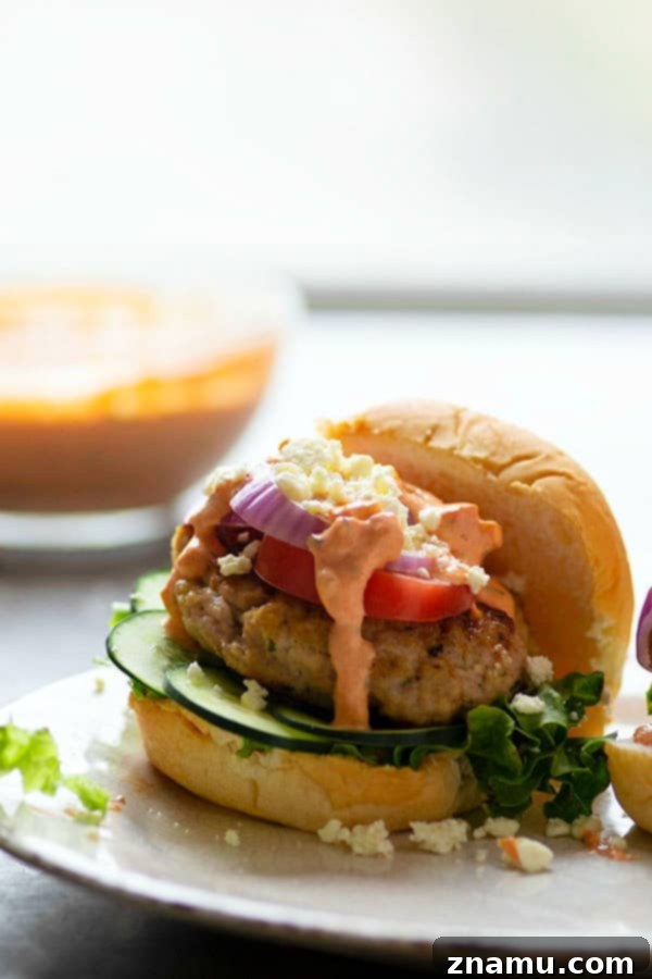 Mediterranean Chicken Burgers with Smoky Red Pepper Tzatziki 3 Grilled chicken burgers are piled high with fresh Greek toppings and a creamy red roasted red pepper tzatziki sauce for an incredibly flavorful Greek twist on burgers!