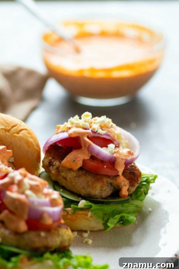 Mediterranean Chicken Burgers with Smoky Red Pepper Tzatziki 5 Grilled chicken burgers are piled high with fresh Greek toppings and a creamy red roasted red pepper tzatziki sauce for an incredibly flavorful Greek twist on burgers!