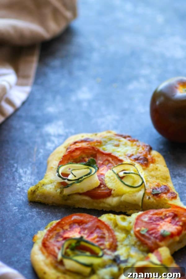 Mediterranean Heirloom Tomato Flatbread with Zucchini, Pesto, and Mozzarella 3 Tender zucchini, flavorful pesto, and juicy summer heirloom tomatoes make for the perfect summer-style pesto flatbread!