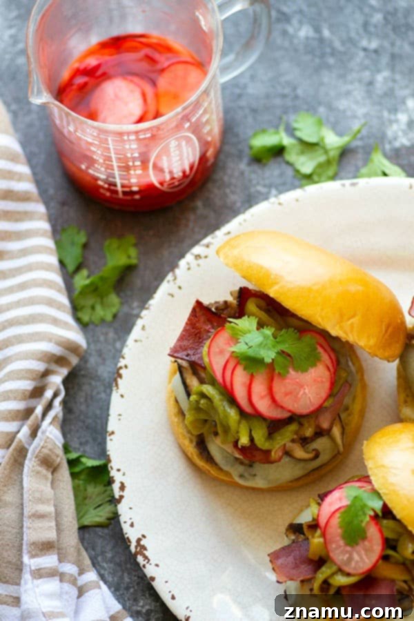 Green chile cheeseburgers are piled high with flavorful roasted chiles, tender shiitake mushrooms, and crispy bacon for the ultimate take on this burger classic!