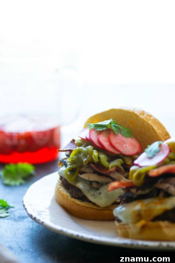 Green chile cheeseburgers are piled high with flavorful roasted chiles, tender shiitake mushrooms, and crispy bacon for the ultimate take on this burger classic!