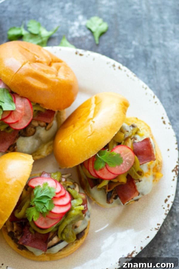 Green chile cheeseburgers are piled high with flavorful roasted chiles, tender shiitake mushrooms, and crispy bacon for the ultimate take on this burger classic!