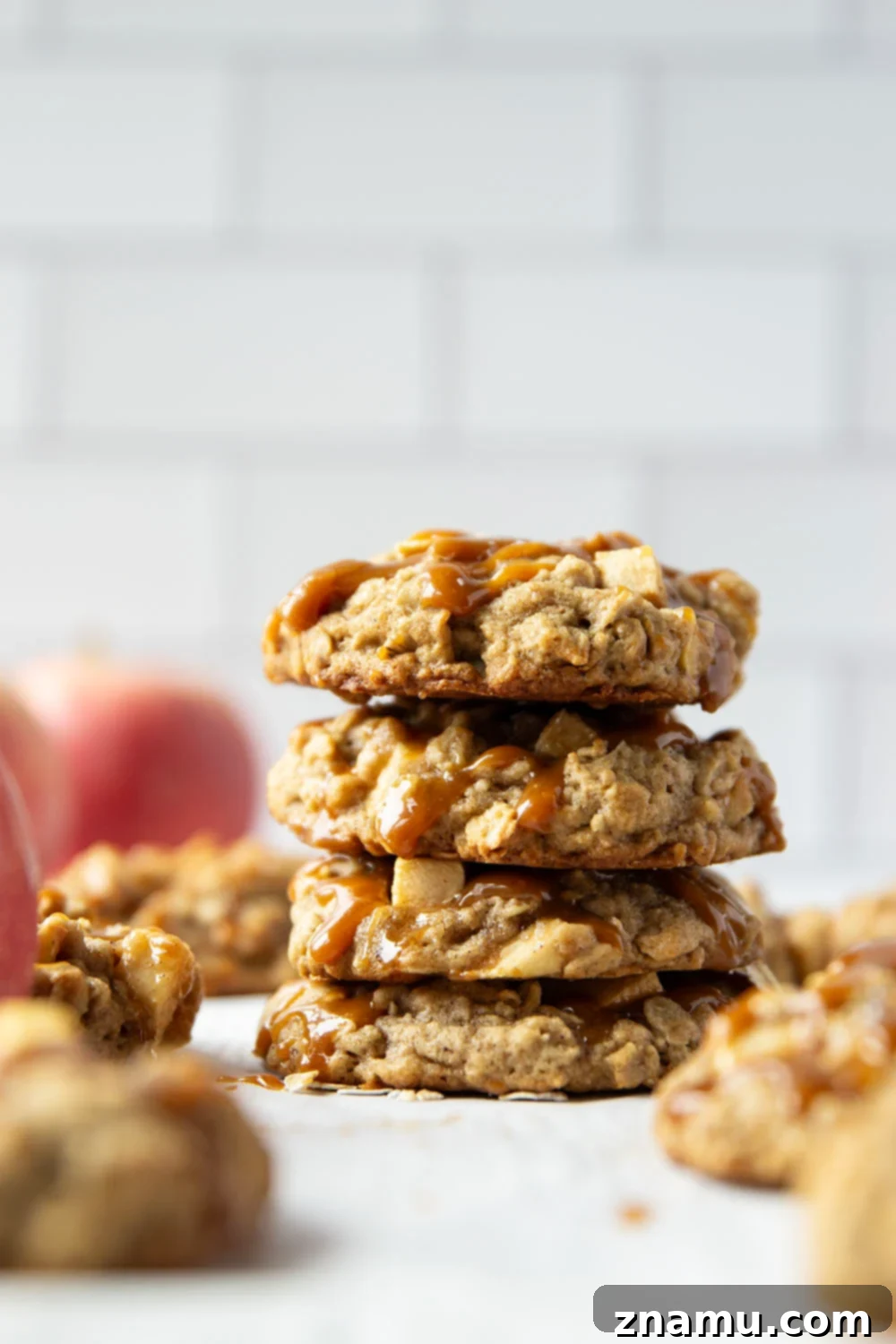 Salted Caramel Apple Oatmeal Cookies 3 Stack of caramel apple oatmeal cookies on a cooling rack, showing chewy texture