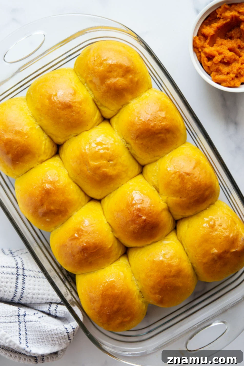 Warm Spiced Pumpkin Rolls 3 A basket of freshly baked fluffy pumpkin dinner rolls, perfect for a fall meal