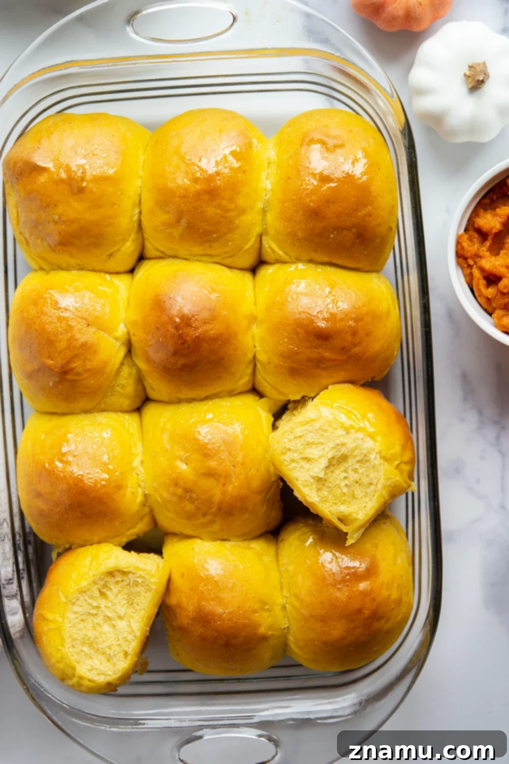 Warm Spiced Pumpkin Rolls 5 Ingredients laid out for making pumpkin dinner rolls, including pumpkin puree, flour, and yeast