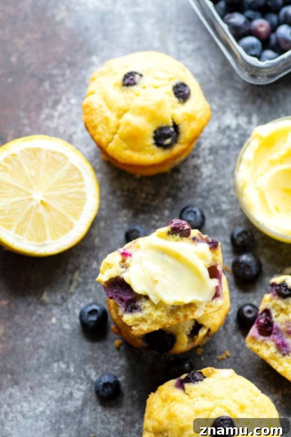 A basket full of freshly baked blueberry cornbread muffins, some cut open to show the fluffy interior and scattered blueberries, inviting a taste.