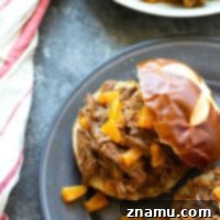 This pineapple BBQ beef is made in minutes using the Instant Pot! The beef is incredibly tender, sweet 'n' smoky, and amazing piled into a warm bun.