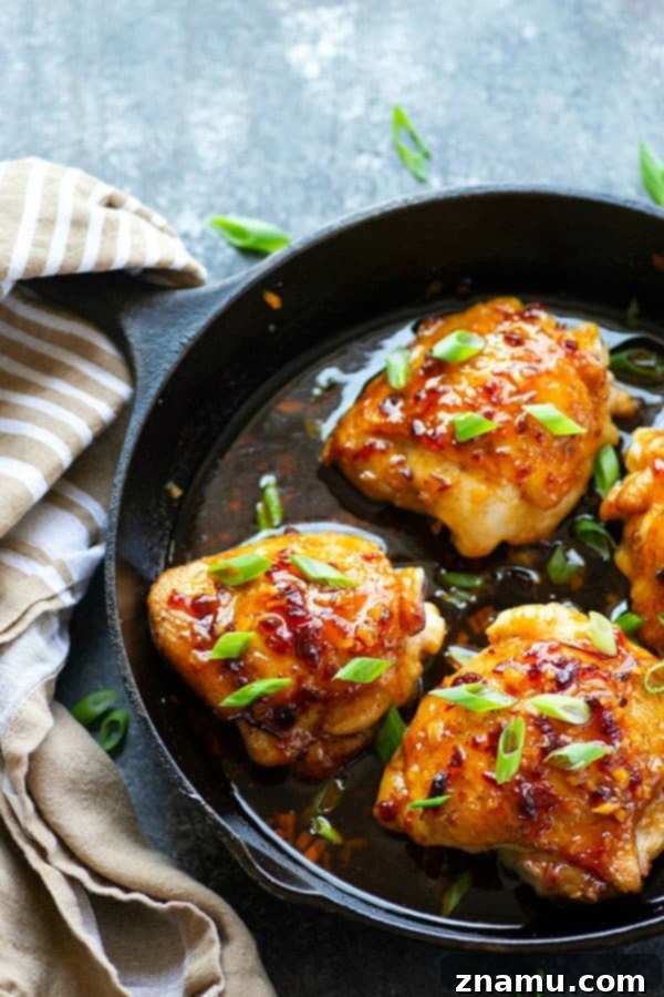 Perfectly glazed sticky honey chipotle chicken thighs with a vibrant sauce, garnished with green onions, showcasing a delicious 30-minute weeknight dinner.