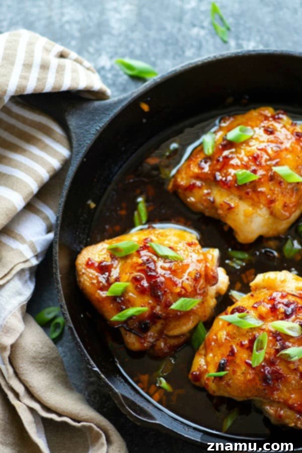Close-up of a pan-seared honey chipotle chicken thigh, glistening with sticky sauce, emphasizing the quick and easy preparation of this delicious dinner.