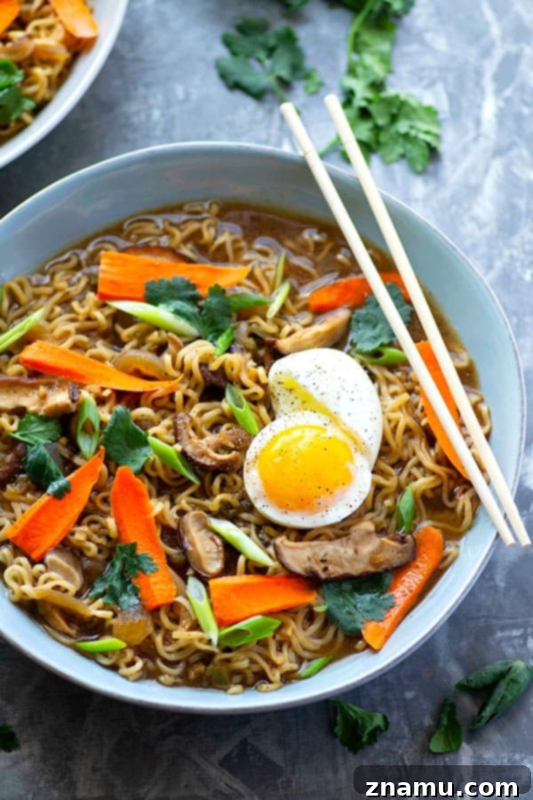 Fiery Miso Ramen with Sweet Caramelized Onions and Earthy Shiitake 4 A person holding a bowl of spicy miso ramen with chopsticks.