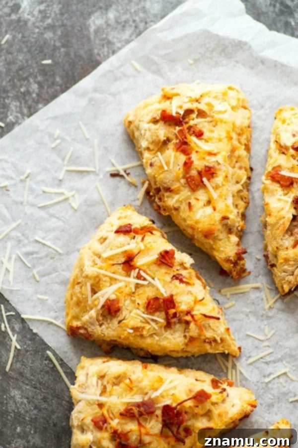 Flaky Asiago Caramelized Onion Bacon Scones with sharp cheese, sweet onions, and crispy bacon bits, perfect for breakfast or as a dinner side.