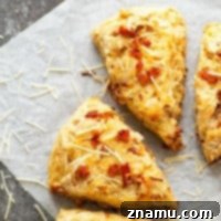 Sharp Asiago cheese and flavorful caramelized onion bits make for incredible savory flavors in these flaky bacon scones! They bake up in only 30 minutes and are a perfect savory breakfast pastry OR dinner side dish.