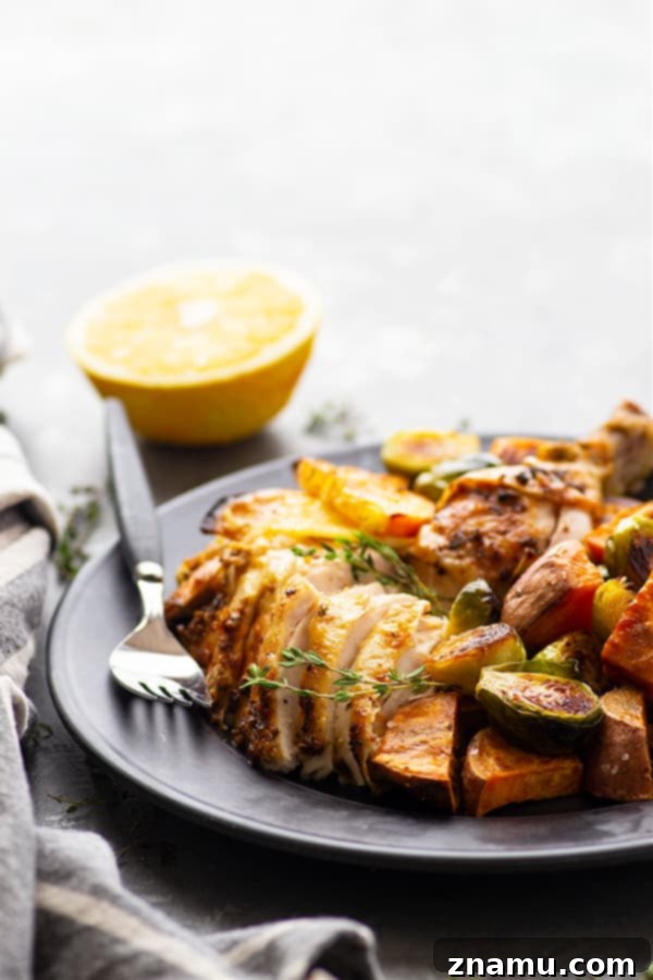 Zesty Ginger Orange Chicken & Roasted Vegetables 5 A whole roasted chicken, glistening with ginger orange butter, carved and served on a platter with roasted sweet potatoes and caramelized Brussels sprouts, ready for a festive meal.