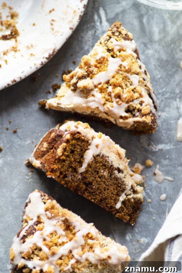 Brown Butter Gingerbread Crumb Coffee Cake 4 A close-up of the streusel topping and glaze on a browned butter gingerbread coffee cake, emphasizing the rich texture and festive appeal of this holiday dessert.