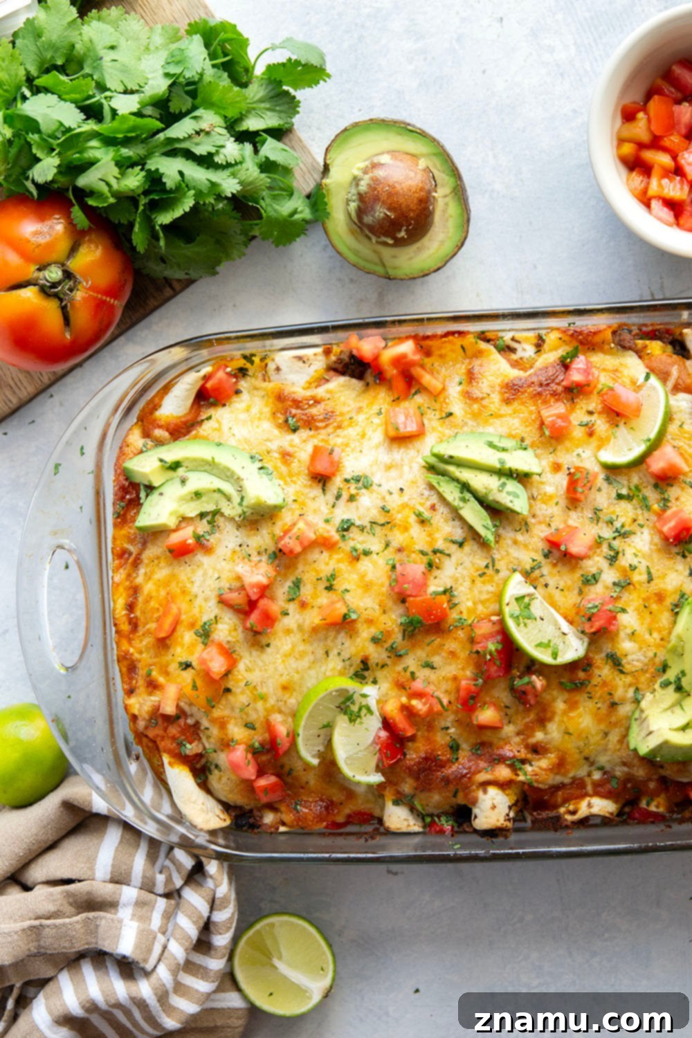 Golden Pumpkin Enchiladas 3 A baking dish filled with golden-brown pumpkin enchiladas, fresh out of the oven, with melted cheese.