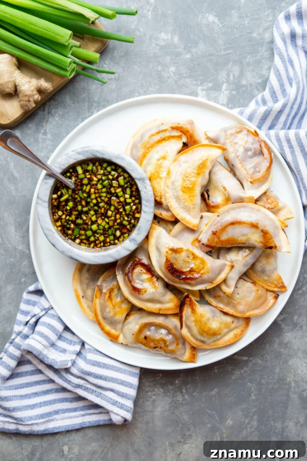 A plate of freshly baked spicy chicken potstickers ready to be served, highlighting their appetizing appearance.