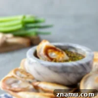 A small image showing prepared spicy chicken potstickers with dipping sauce.