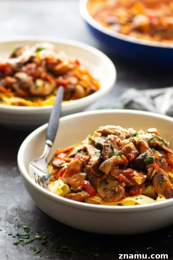 A large pot filled with savory shiitake mushroom ragu simmering on the stove