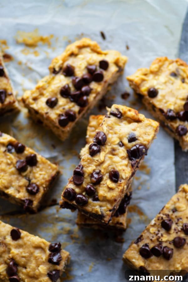A plate of warm banana chocolate chip oatmeal breakfast bars with melted chocolate, ready to be enjoyed.