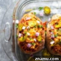 Smoky BBQ Chicken Loaded Sweet Potatoes 7 BBQ chicken stuffed sweet potatoes feature saucy barbecue pulled chicken stuffed into fluffy baked sweet potatoes and piled with all your favorite toppings!