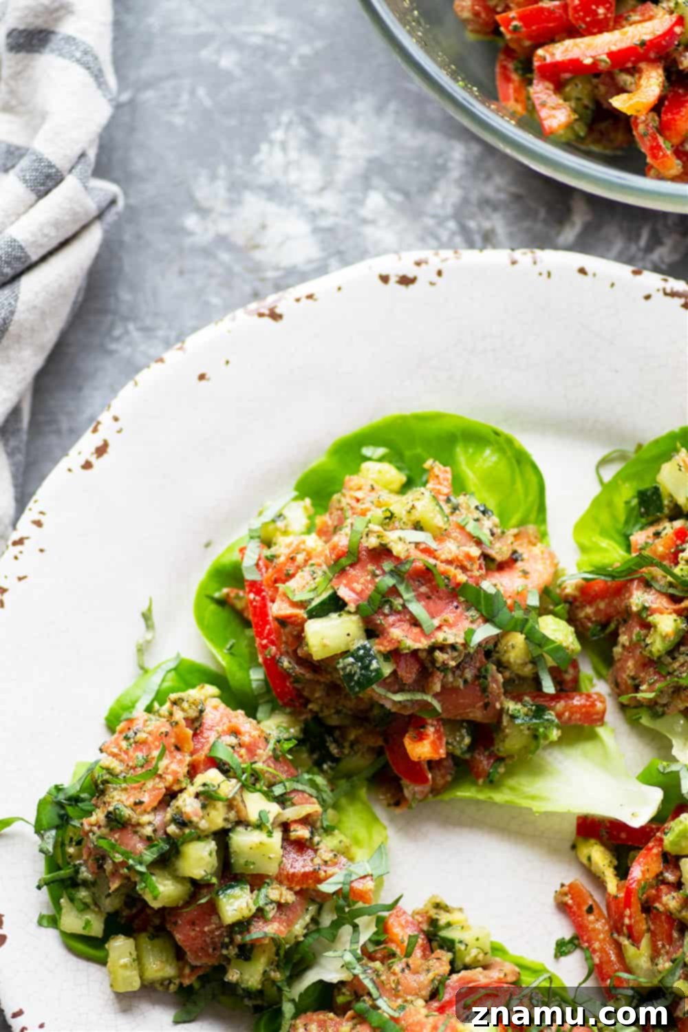 Freshly assembled Smoked Salmon Lettuce Wraps ready to be served, garnished with fresh herbs.