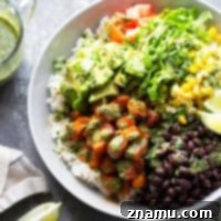 Blackened butternut squash burrito bowls are piled high with all the fixins' and a flavorful fresh mojo sauce for a healthy take on burrito bowls! Completely vegetarian AND vegan!