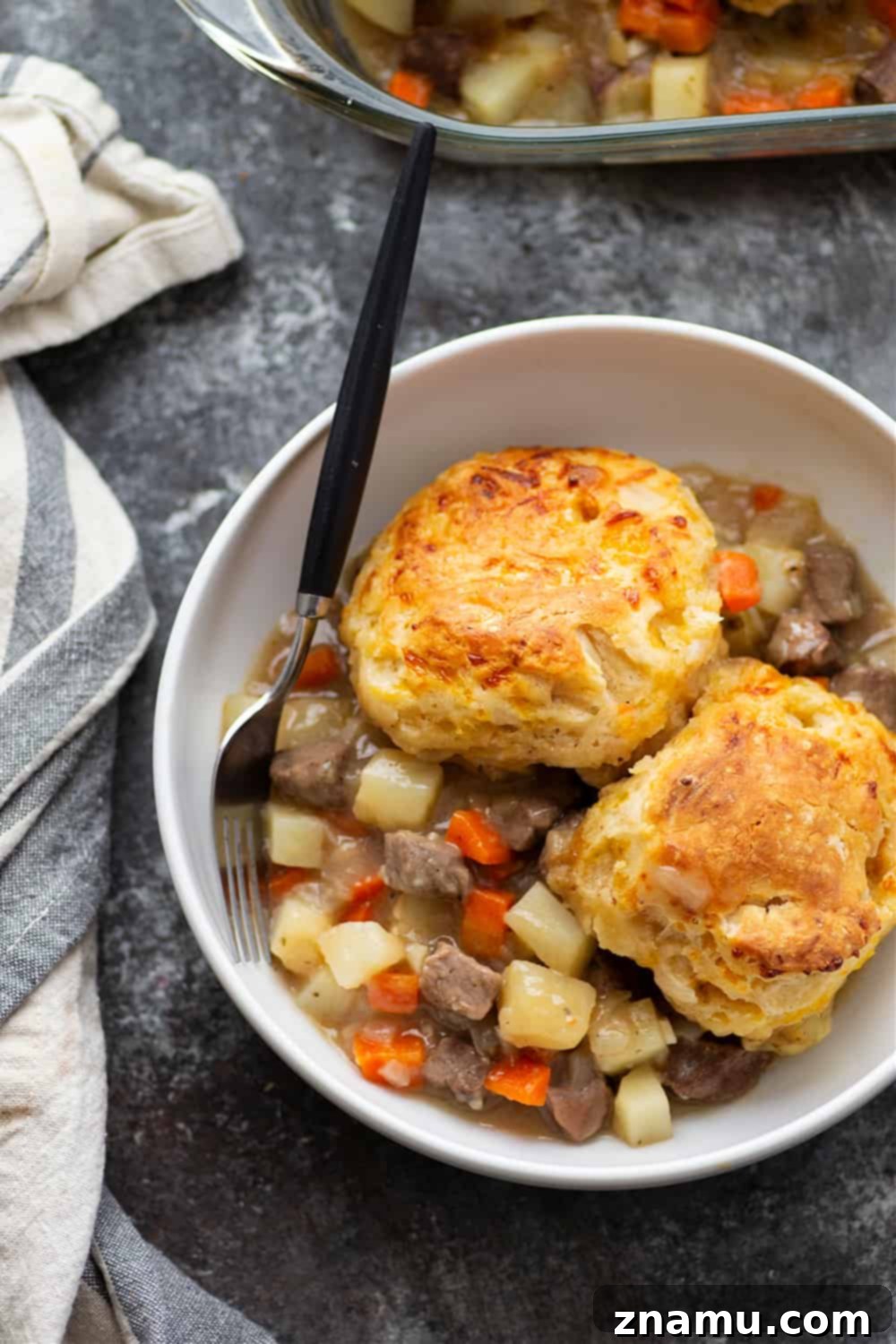 Savory Steak Pie with Cheddar Biscuit Crust 2 Loaded with steak and potatoes in a rich beer sauce and topped with buttery cheddar biscuits, this steak pot pie is an irresistible weeknight comfort food!