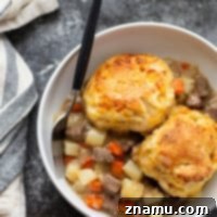 Loaded with steak and potatoes in a rich beer sauce and topped with buttery cheddar biscuits, this steak pot pie is an irresistible weeknight comfort food!