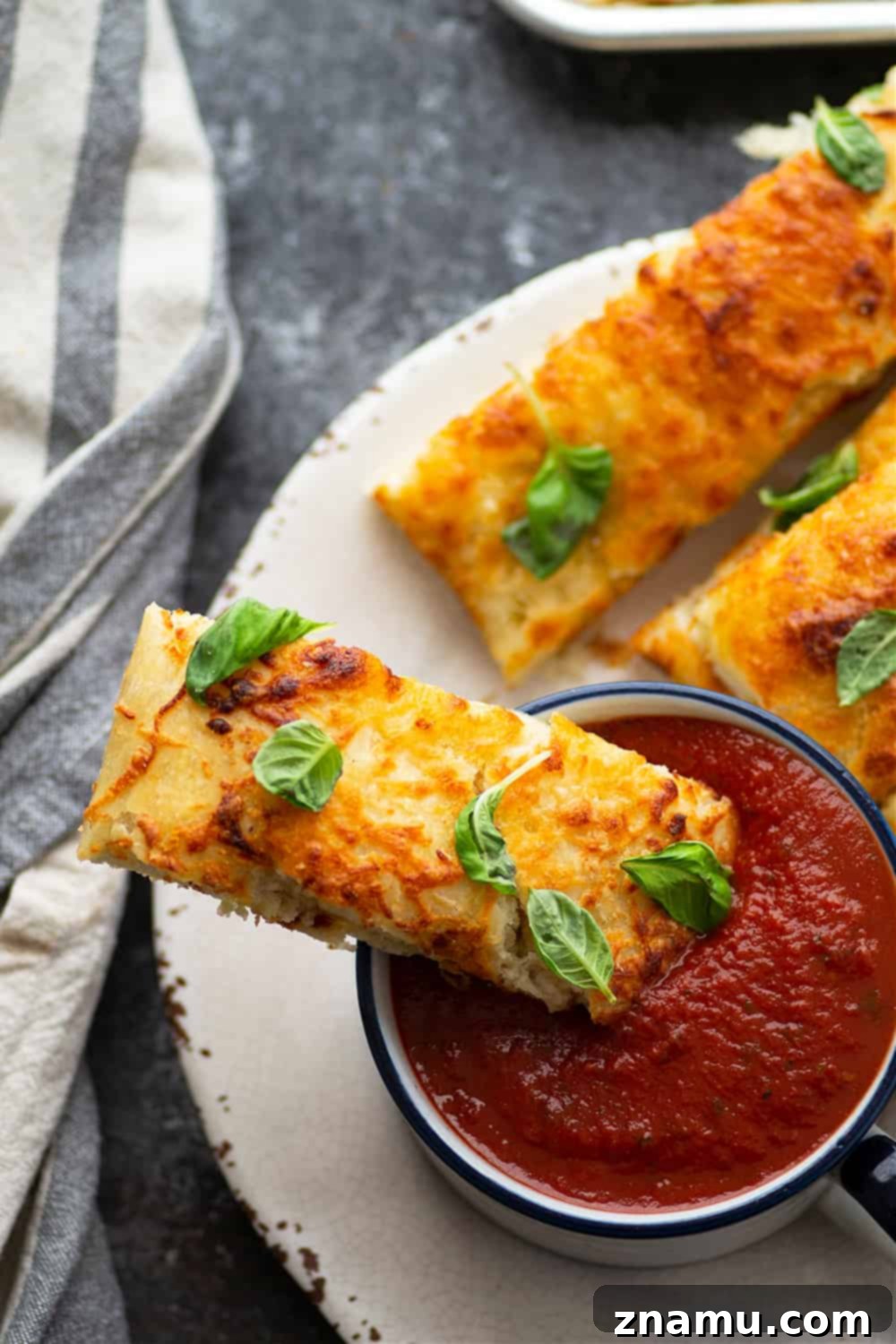Savory Cheese Focaccia Sticks 5 A generous portion of Cheesy Pizza Focaccia Breadsticks drizzled with olive oil and sprinkled with garlic powder before baking.