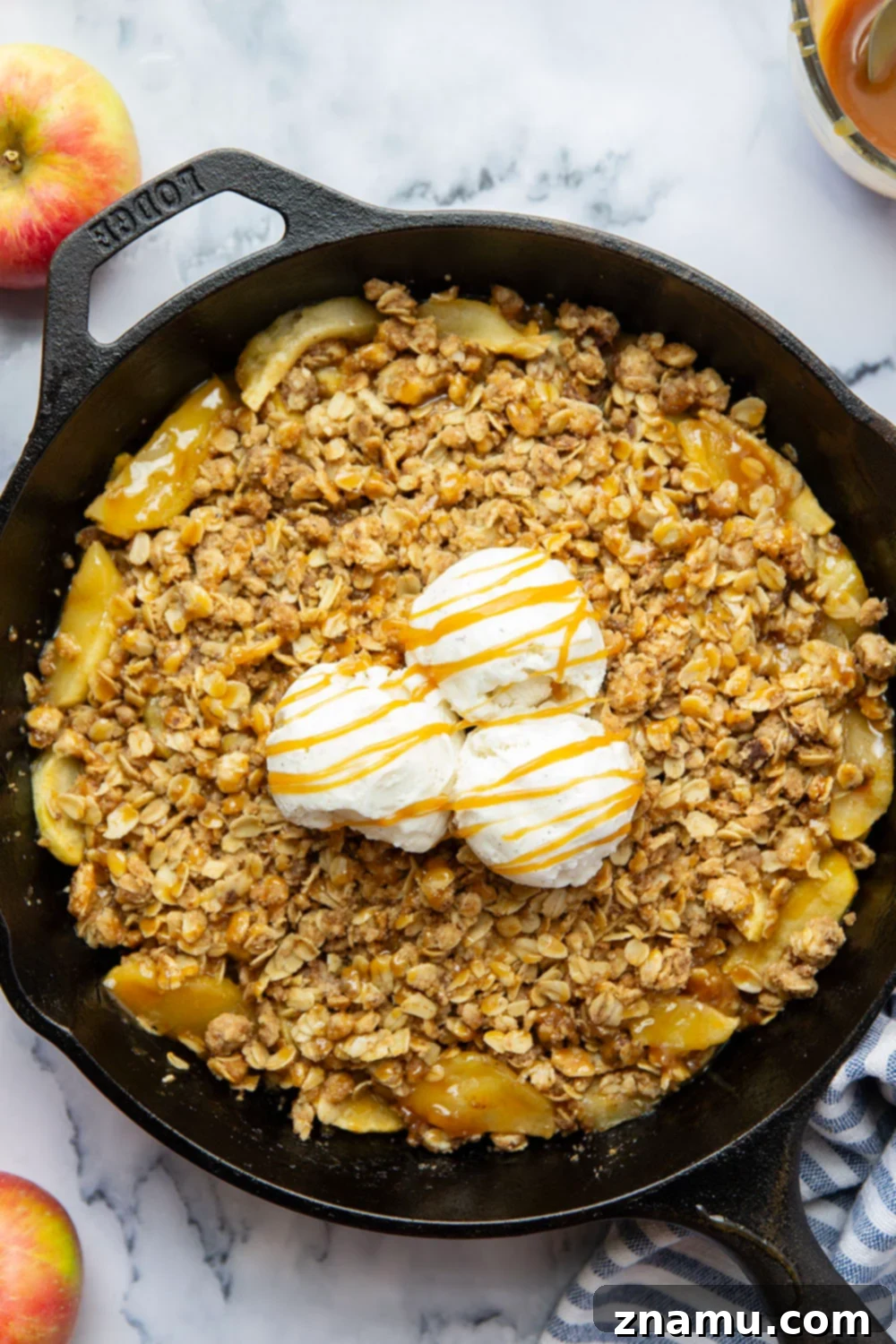 Gooey Skillet Caramel Apple Crisp 5 A close-up of a spoonful of Skillet Caramel Apple Crisp, showing the golden streusel, tender apples, and gooey caramel.